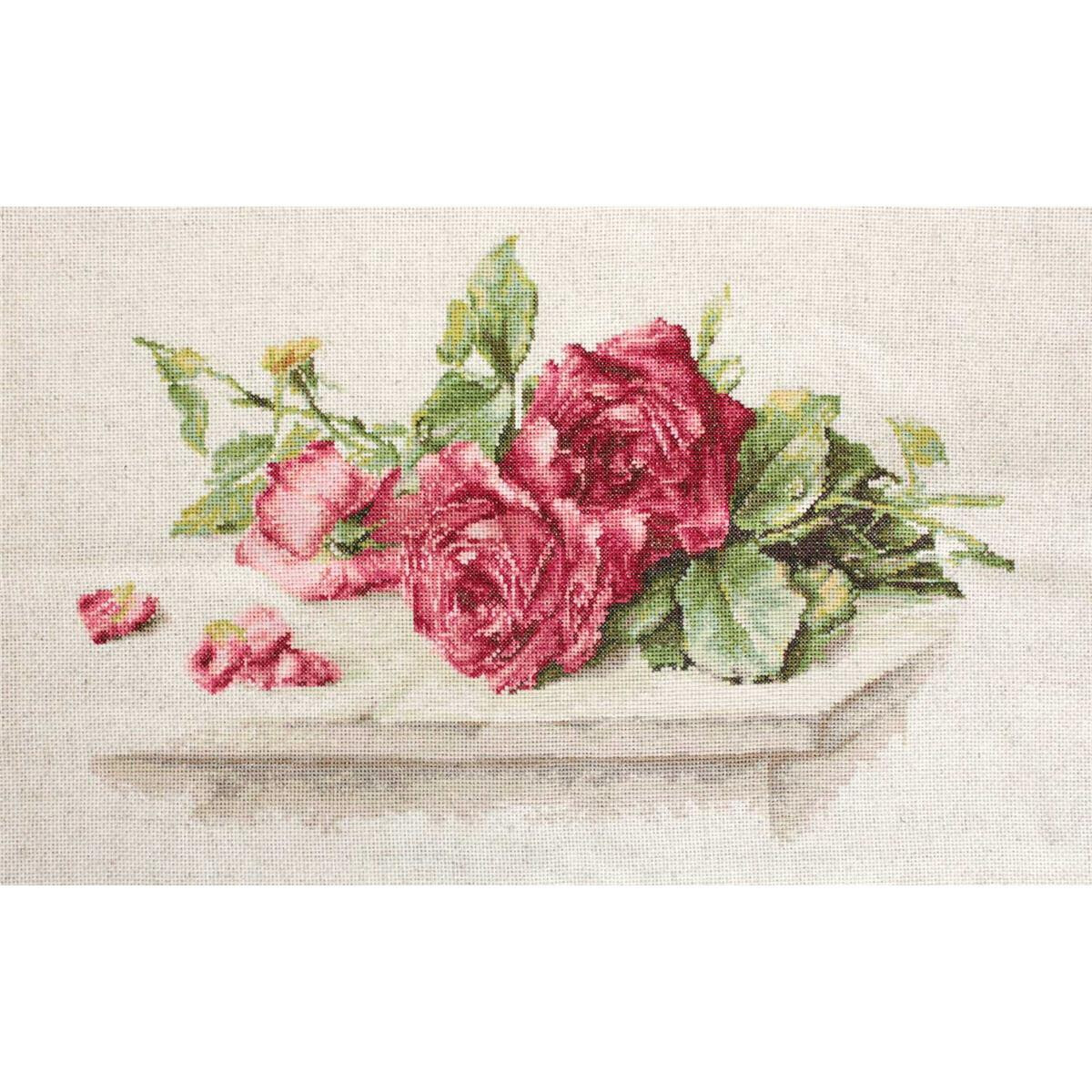 Een borduurpakket van Luca bevat een tros felroze rozen...