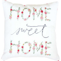 A white square sofa cushion with a decorative embroidered design. The words HOME SWEET HOME are embroidered in a mixture of floral and script styles. The words HOME and HOME are made up of colorful flowers and resemble an adorable Luca-s embroidery pack, while SWEET is written in blue cursive and has a cozy feel.