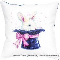 A decorative cushion with the image of a white rabbit with pink ears peeking out of a black wizard cylinder with a pink bow. The cushion is white, decorated in the style of a Luca-s embroidery pack, with little pink hearts floating around the rabbit-s head. The text reads: without frame (decoration).