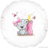 Embroidery of a gray teddy bear with a pink bow, sitting in front of a baby bottle and pink flowers. The bear has a shy, bashful expression and two butterflies hover above him, creating a whimsical and playful atmosphere. This adorable Luca-s embroidery pack is on a round, white fabric.