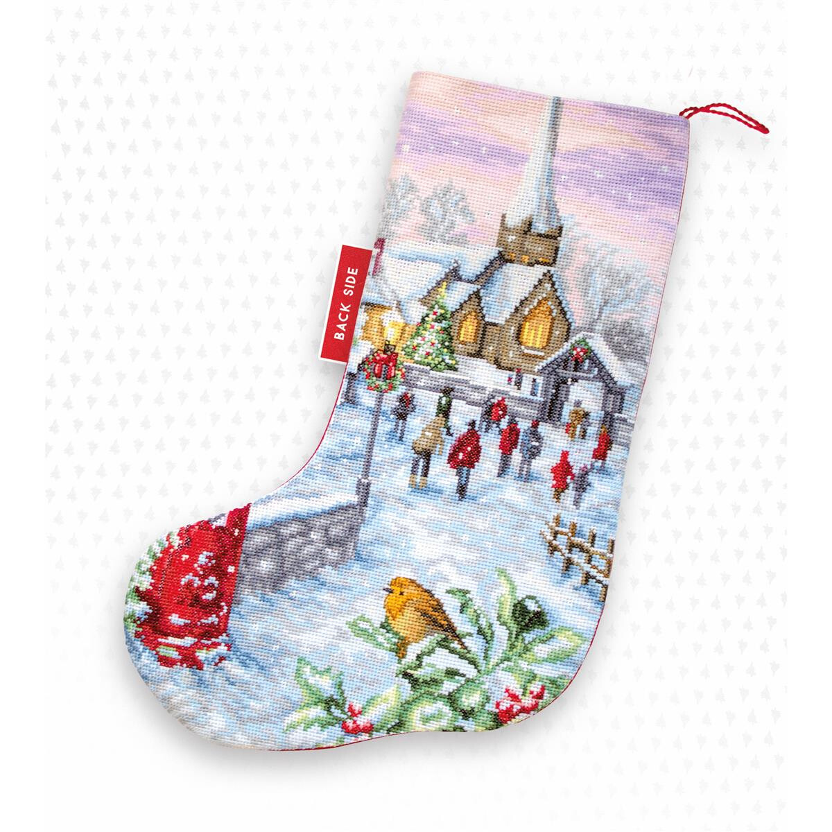 A Christmas stocking decorated with a snowy village scene...