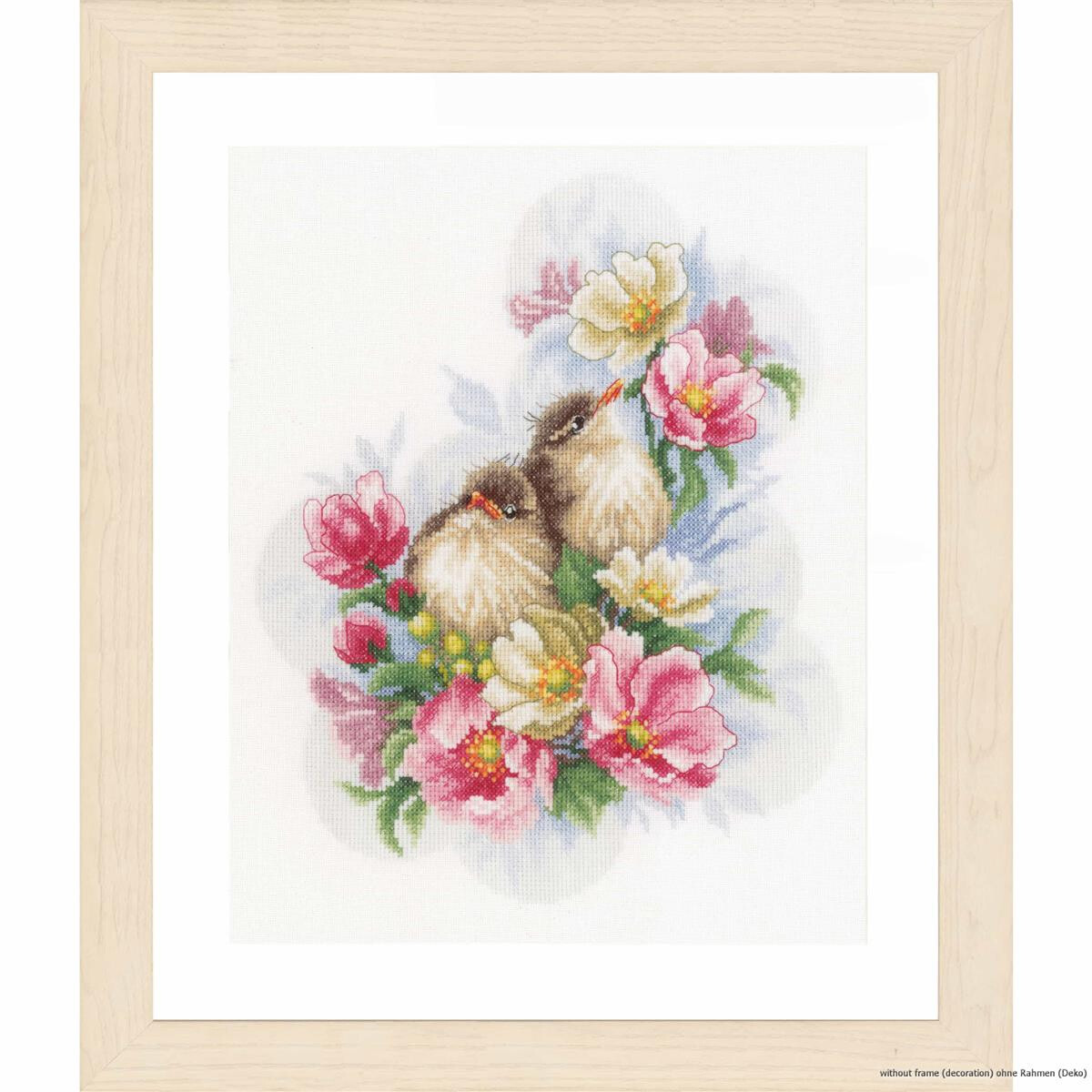 A framed artwork depicts two small birds sitting amidst a...