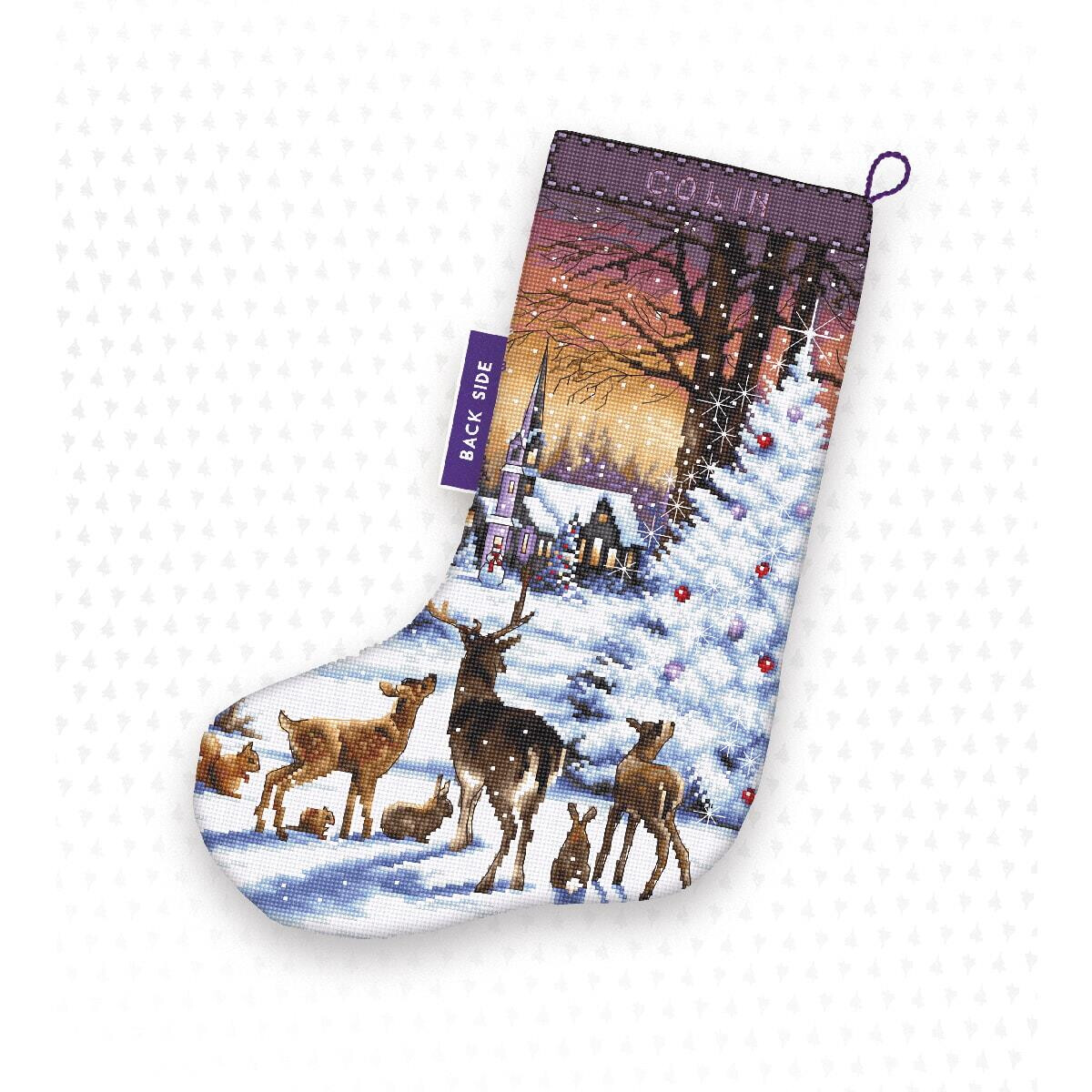 A Christmas stocking with a winter landscape in which...