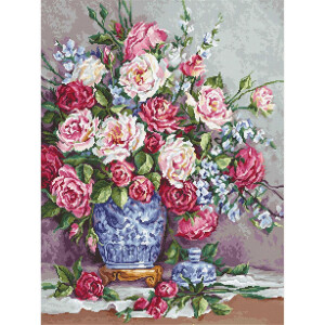 A vibrant floral arrangement of pink, white and red roses in a blue and white porcelain vase. The bouquet contains delicate green leaves and small white blooms, with an ornate lid resting next to the vase on a white lace tablecloth against a soft, neutral background - perfect to complement your Luca-s embroidery pack.