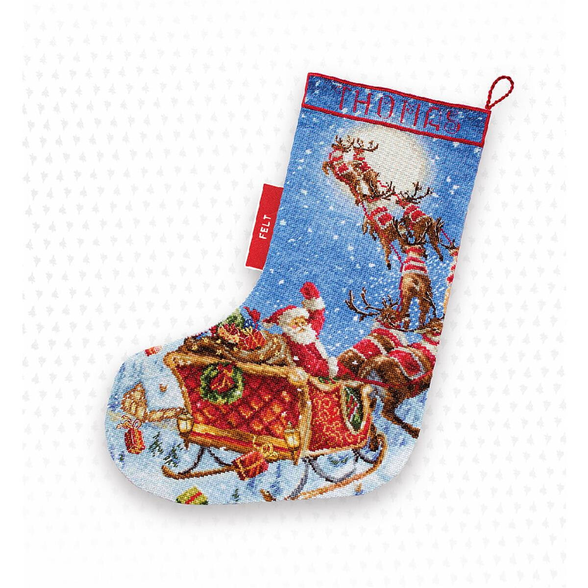 A festive Christmas stocking depicts a snowy scene with...