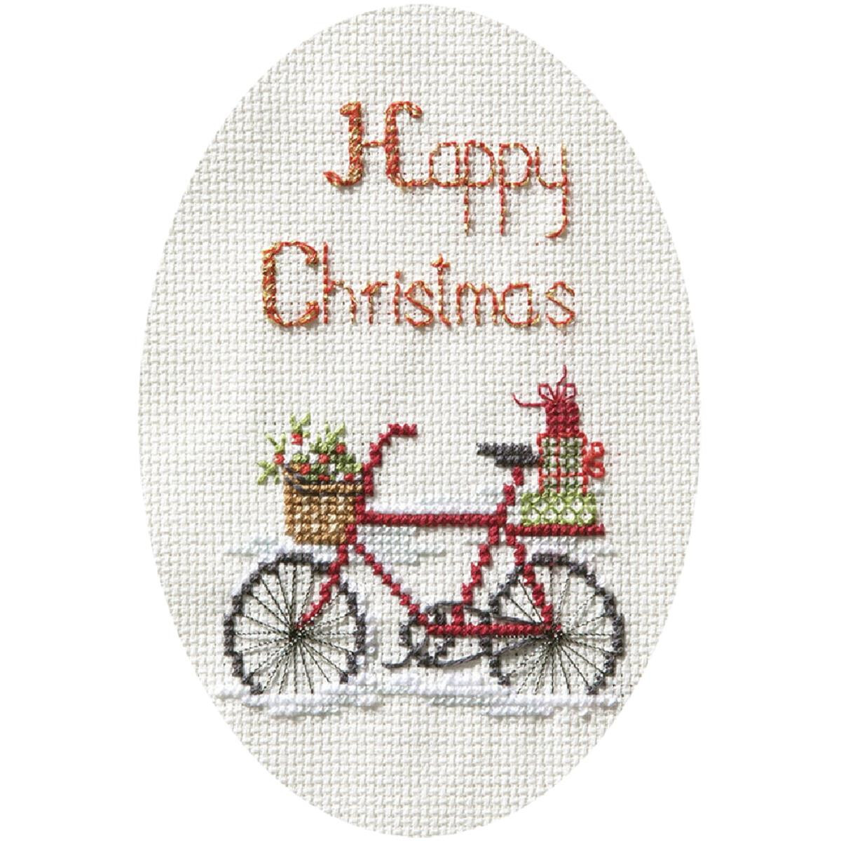 An oval cross stitch design features the words Merry...