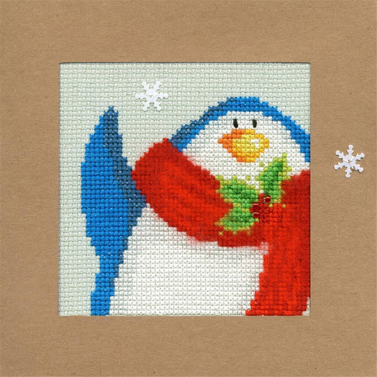 An embroidery kit with cross stitch of a cheerful penguin...