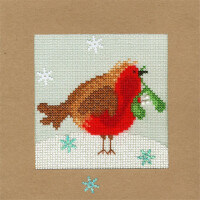 Eine Stickpackung eines Rotkehlchens im Kreuzstich von Bothy Threads hält eine grüne Mistel im Schnabel. Der Vogel steht auf schneeweißem Grund mit verstreuten Schneeflocken, die in Weiß und Hellblau gestickt sind. Der Hintergrund ist hellgrau und der Rand ist schlicht braun.