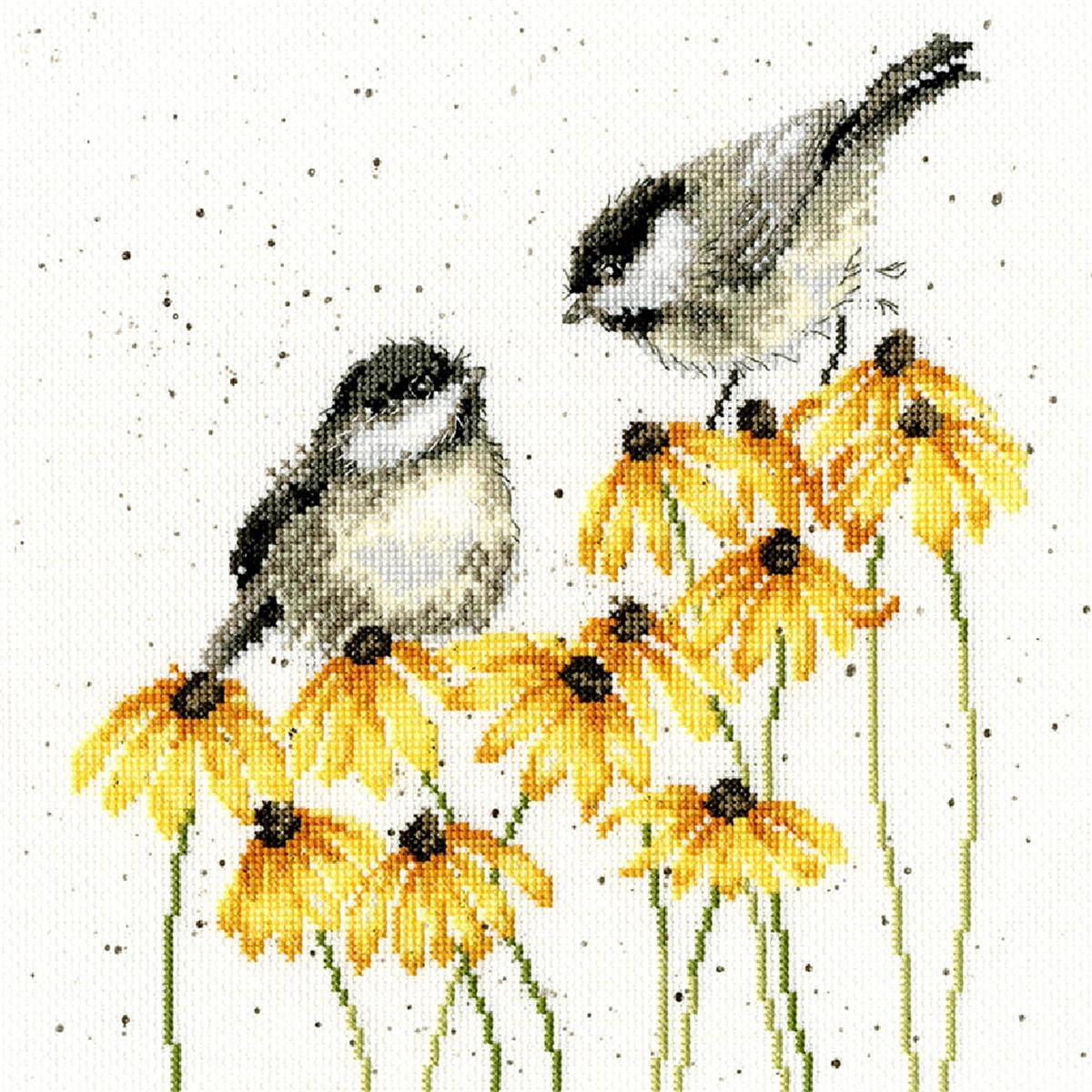 Cross stitch artwork with two small birds sitting on a...