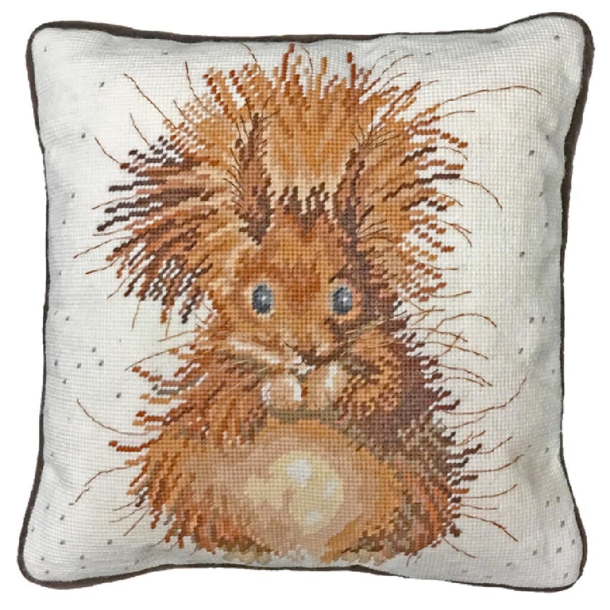 A decorative cushion with a cross stitch design of a...