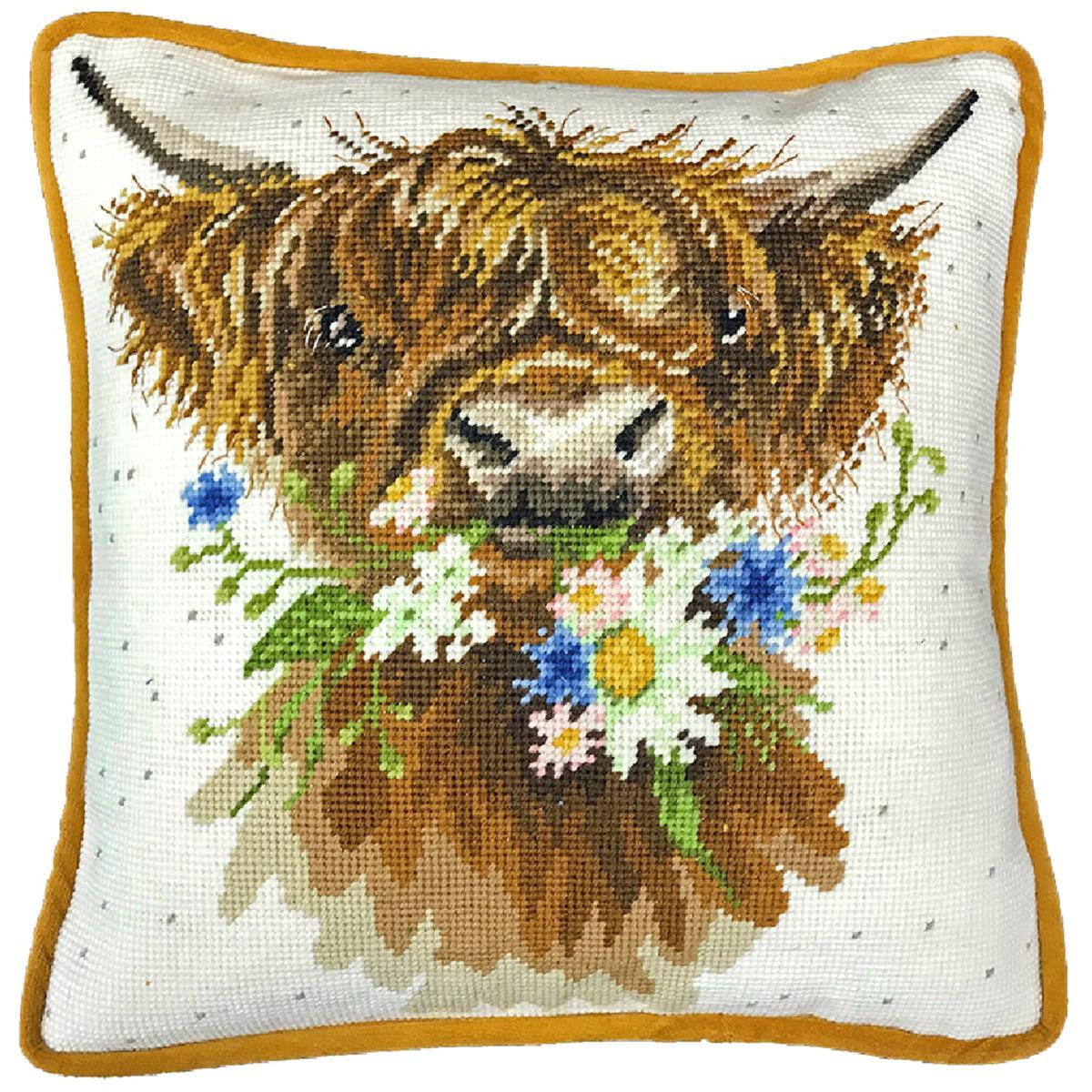 A square cushion with a cross stitch image of a brown...