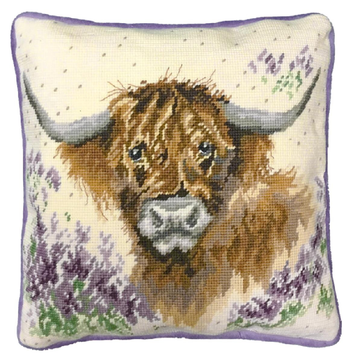 A square cushion features a detailed cross stitch...