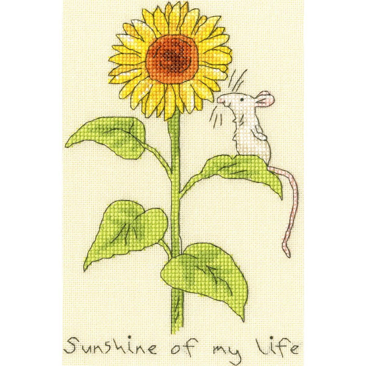 A cross-stitch design shows a large sunflower with large...