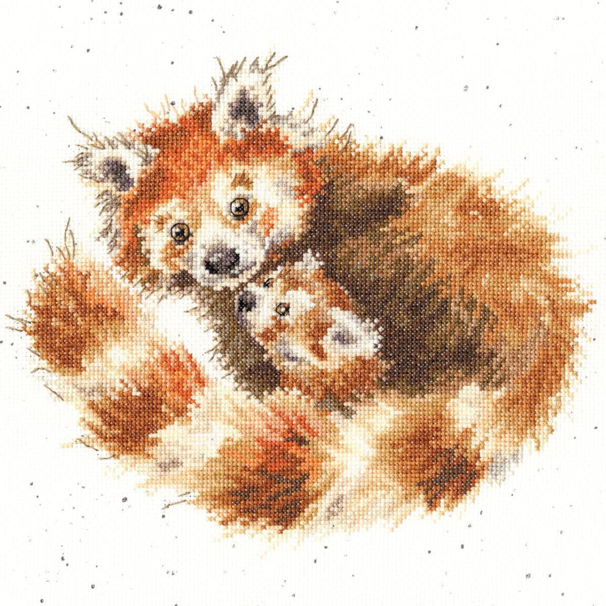 A cross-stitch embroidery with two red pandas cuddled...