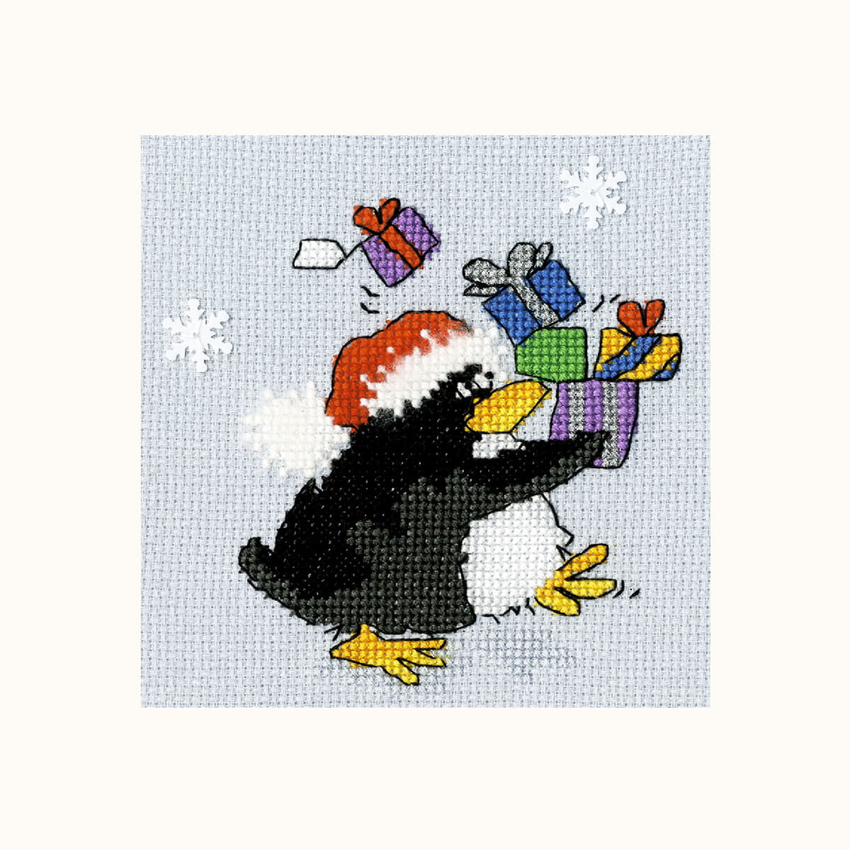 An enchanting embroidered picture of a black penguin with...