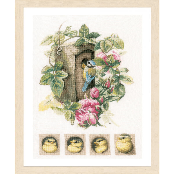 An embroidery pack from Lanarte, which resembles cross-stitch patterns, shows a bird sitting in a tree hollow, surrounded by green leaves and pink flowers. Below the main scene, four smaller square pictures show a baby bird growing from chick to fledgling. The frame is made of light wood with a beige matt finish.