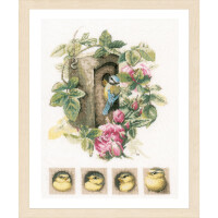 An embroidery pack from Lanarte, which resembles cross-stitch patterns, shows a bird sitting in a tree hollow, surrounded by green leaves and pink flowers. Below the main scene, four smaller square pictures show a baby bird growing from chick to fledgling. The frame is made of light wood with a beige matt finish.