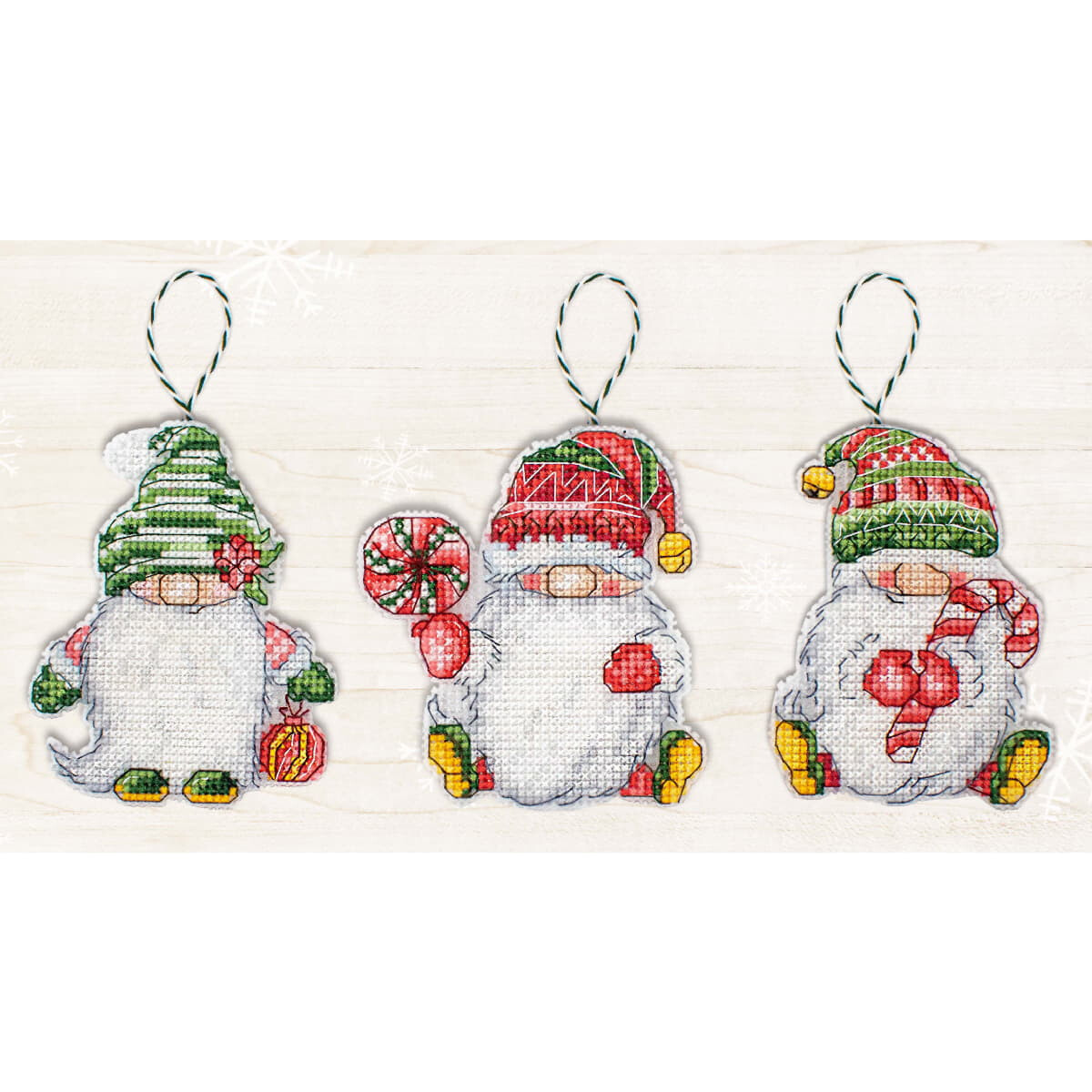Three festive gnome ornaments are displayed in a row....