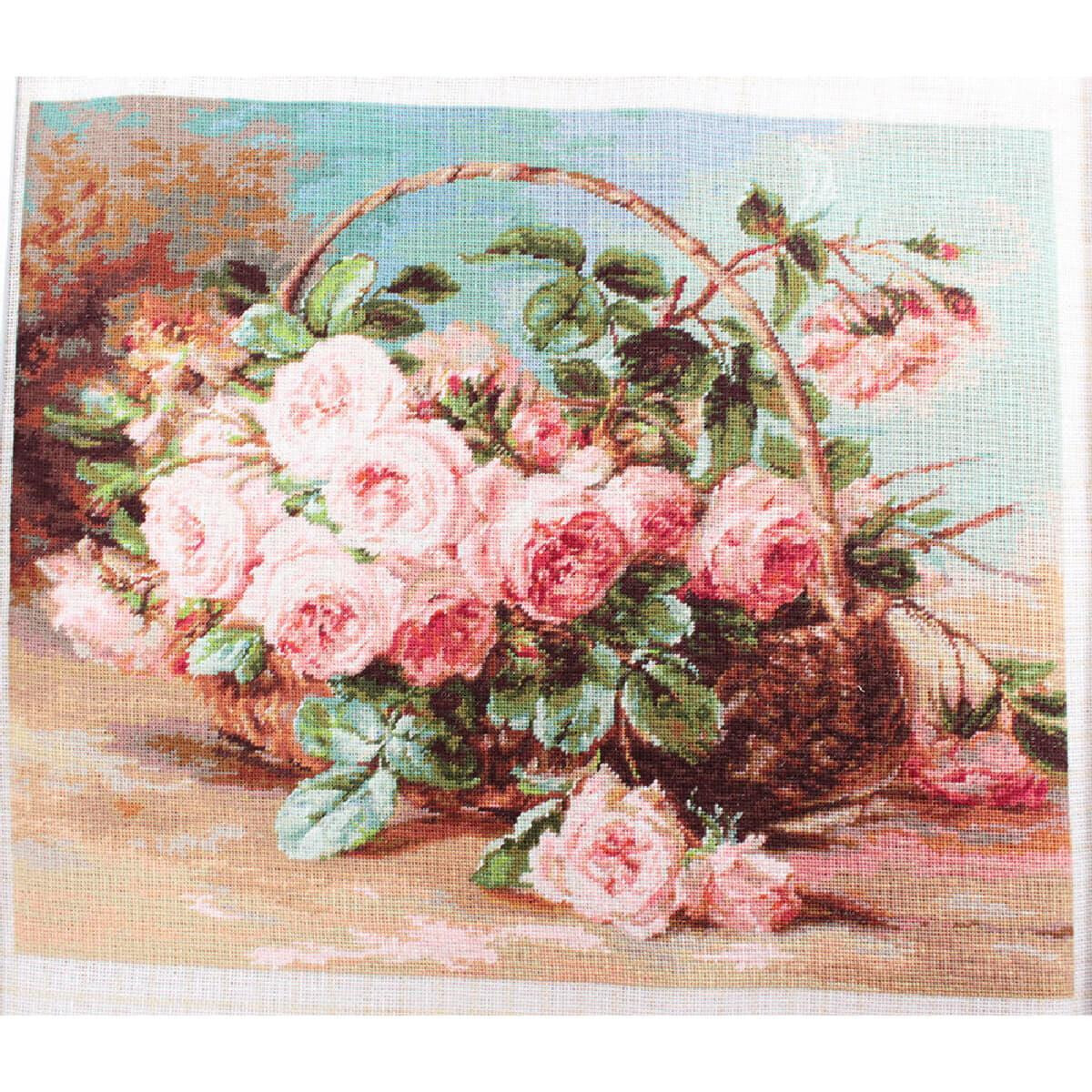 The picture shows a woven basket with a lush bouquet of...
