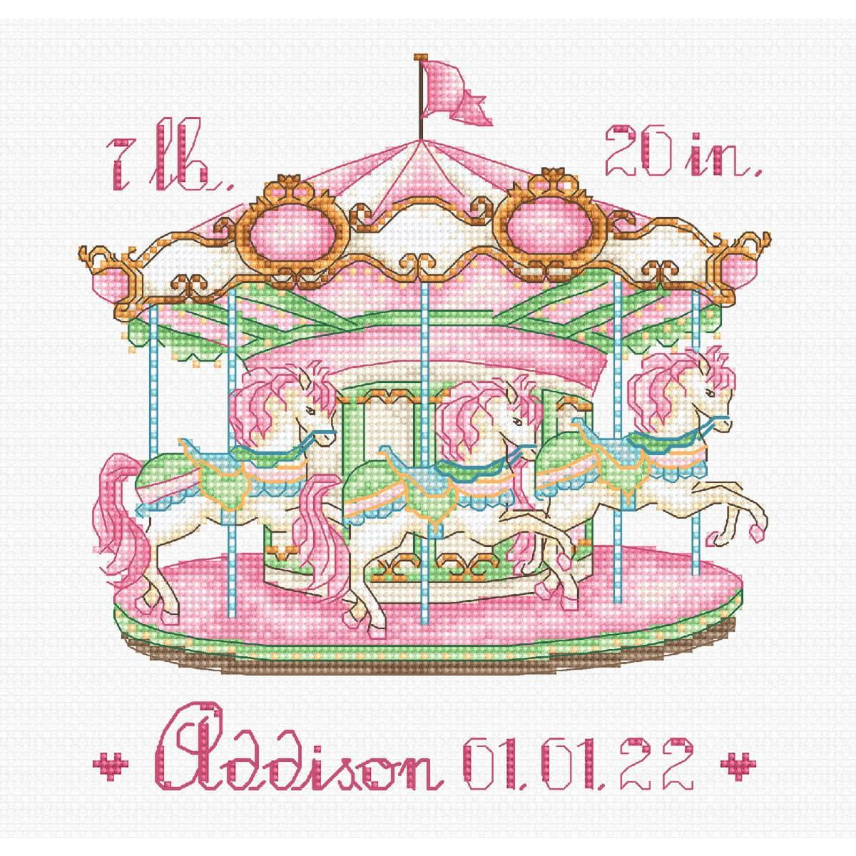 A colorful cross stitch design shows a pink carousel with...