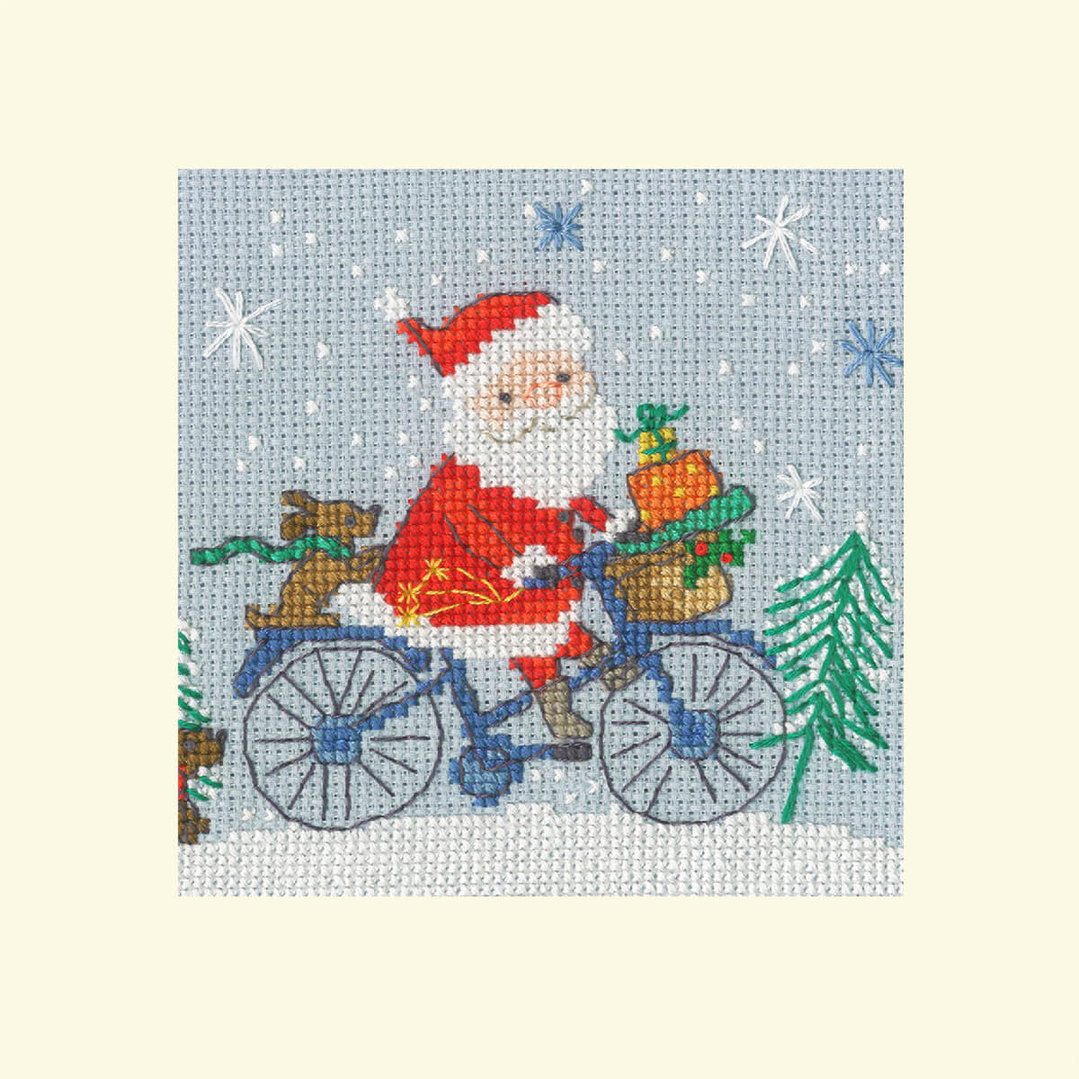 A cross-stitch picture of Santa Claus riding his bike in...