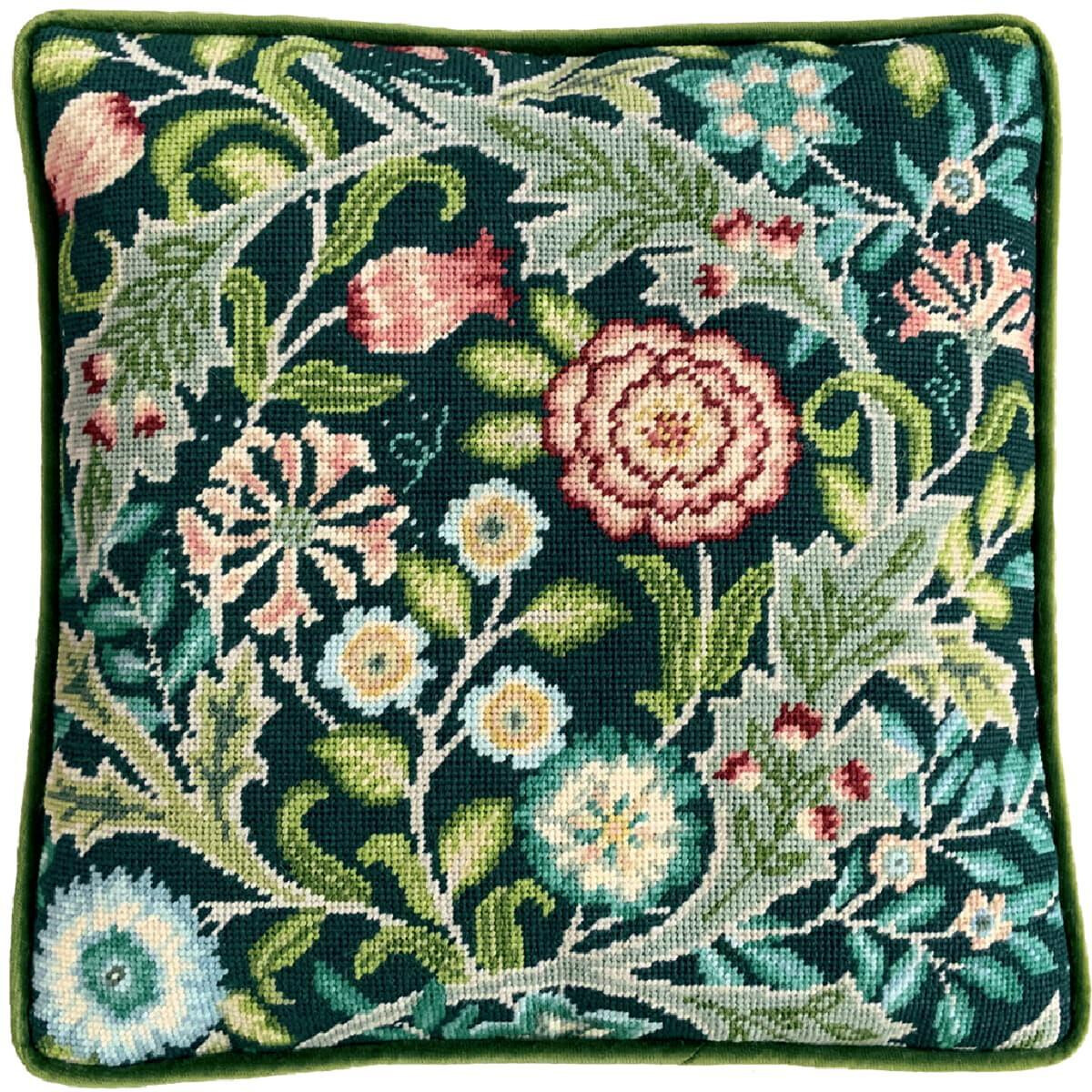 A square, intricately embroidered cushion with a floral...