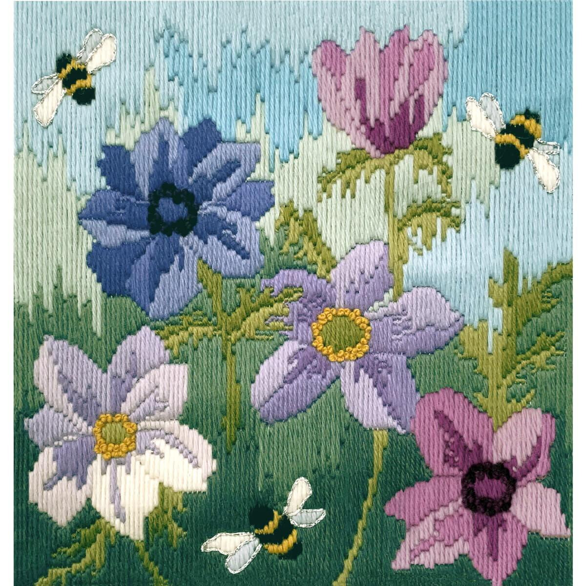 Embroidery of various flowers in shades of blue, purple,...