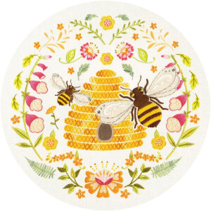 A round embroidery pack from Bothy Threads features two bees approaching a yellow beehive adorned with intricate patterns. Surrounding the hive are vibrant floral patterns, including pink and orange flowers, green leaves and delicate stems that form a symmetrical, decorative border around the central hive in this charming cross stitch piece.