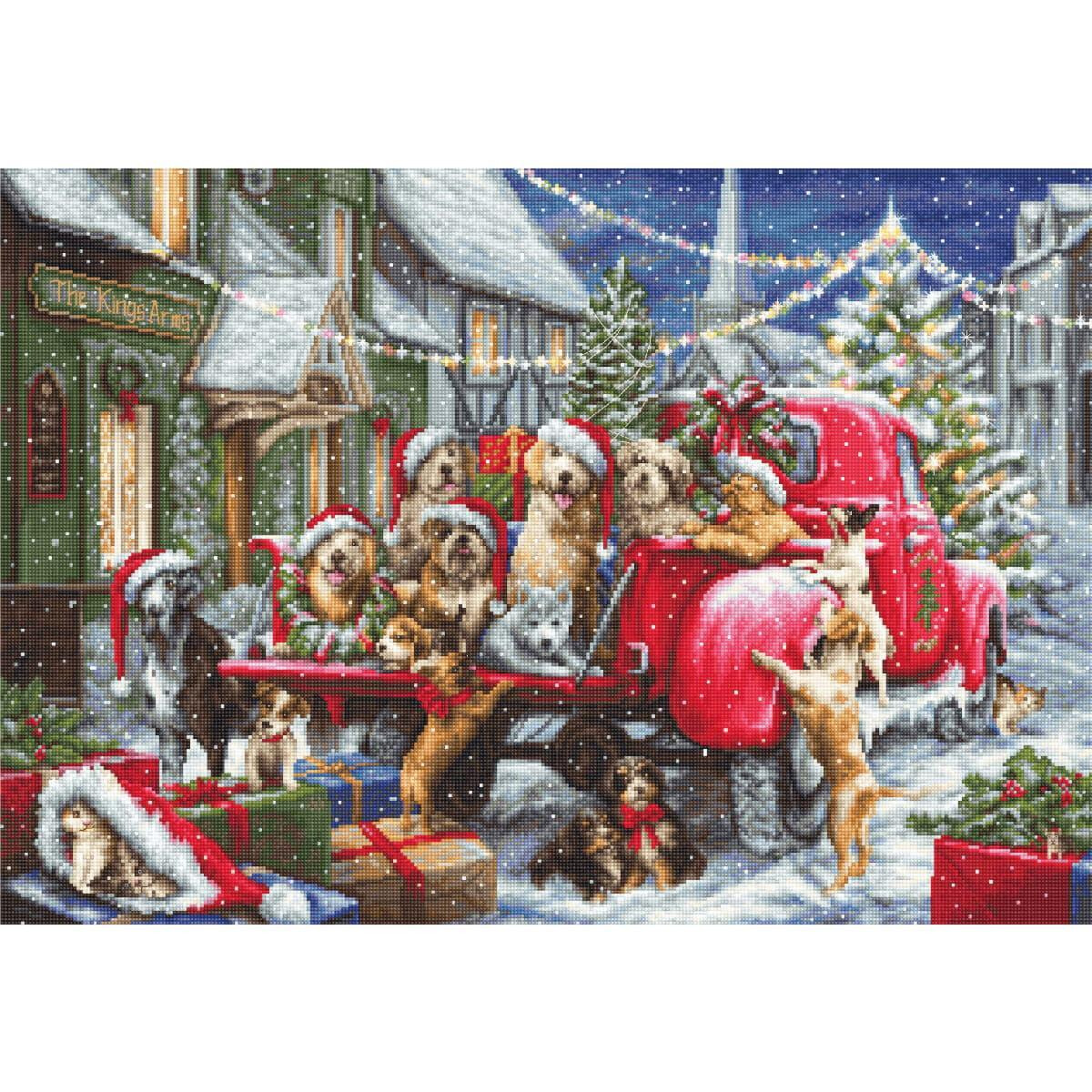 A festive scene shows a red vintage truck loaded with...