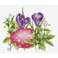 A cross-stitch pattern with two purple flowering crocuses surrounded by green leaves and foliage. In the foreground is a large pink egg with white and yellow dots. This embroidery pack from Luca-s is printed on a white fabric canvas, highlighting the colorful flower and egg design.