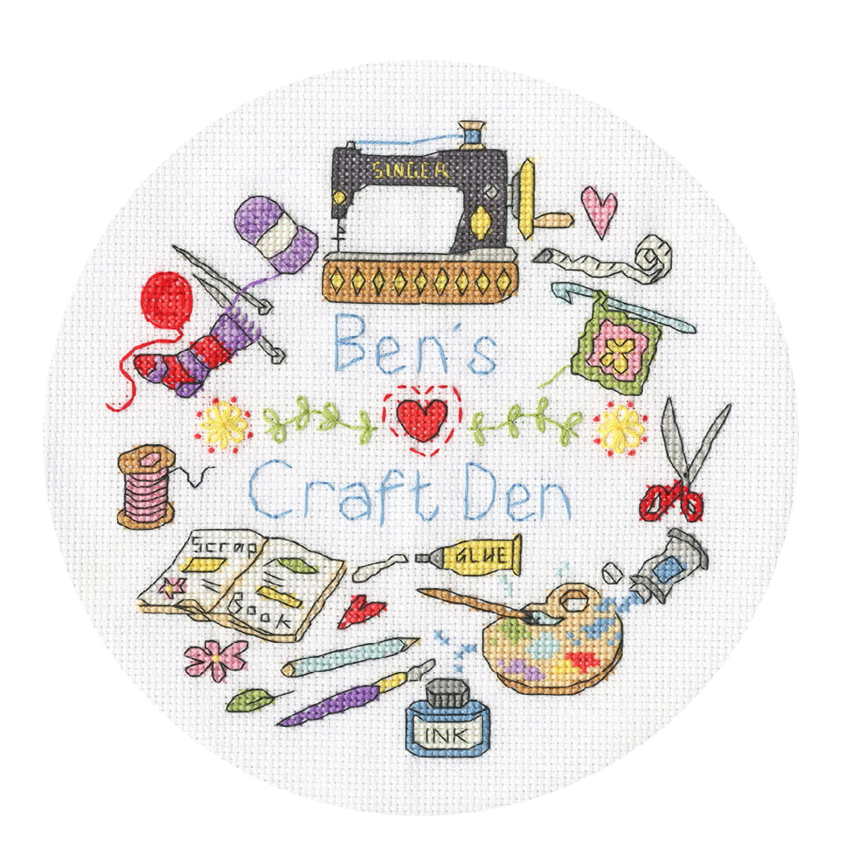 A circular picture decorated with cross stitches and...