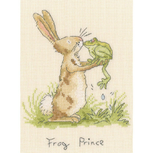The image is a Bothy Threads embroidery pack showing a rabbit holding a frog with their noses touching. The rabbit is standing on its hind legs and has light brown fur with darker patches. It is surrounded by grass and the text Frog King is embroidered at the bottom in cross stitch style.