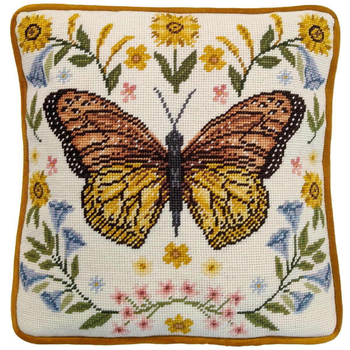 A square cushion features detailed embroidery of a...