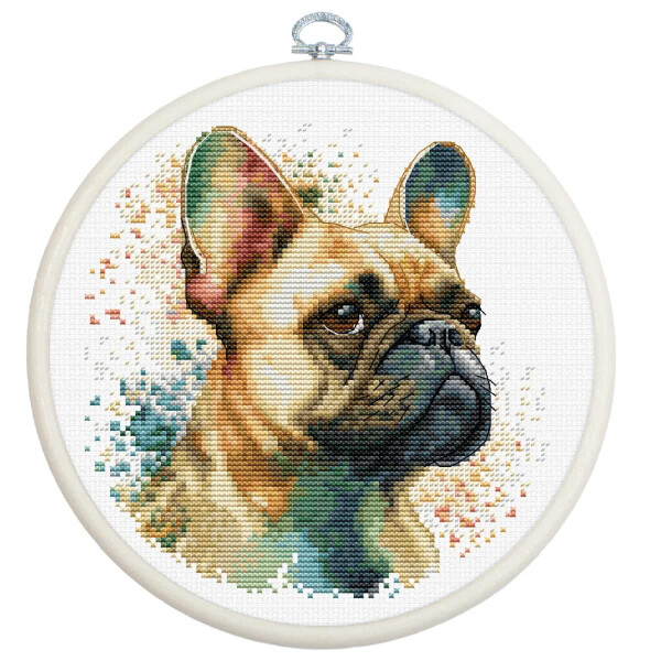 A detailed embroidered portrait of a French bulldog is framed in a round embroidery hoop. With a Luca-s embroidery pack, the dog is depicted in a realistic, multicolored needlework style, with alert, attentive ears and a serious facial expression. The background consists of abstract, multicolored patterns.