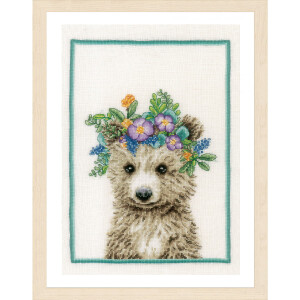 This cross stitch pattern from Lanarte embroidery kit shows a bear cub with flowers on its head. The cub has fluffy brown fur and inquisitive eyes, adorned with a bright flower crown in shades of purple, blue, green and orange. The picture is finished with a simple green border and a light-colored wooden frame, perfect for cross stitch pattern lovers.