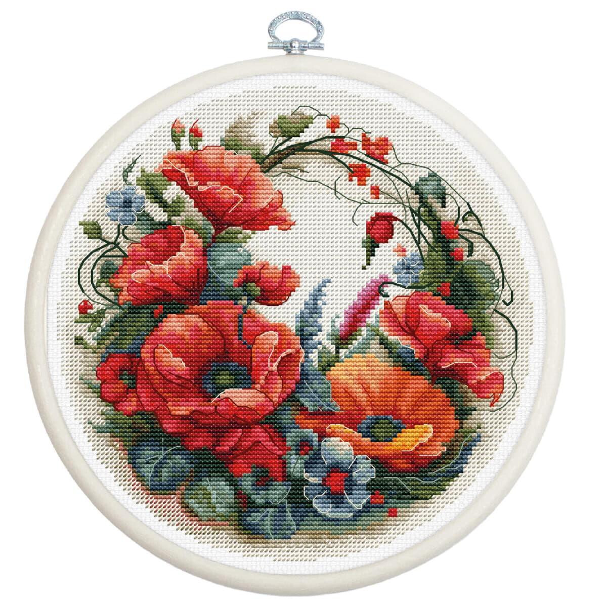 An embroidery hoop with an intricate cross stitch design...