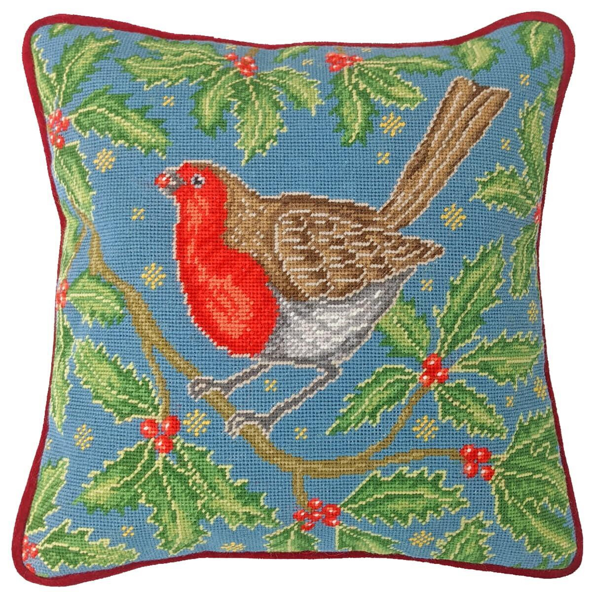 A colorful square pillow features an embroidered robin,...