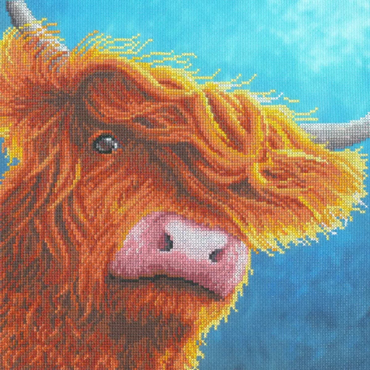 Cross stitch picture of a highland cow, created from an...