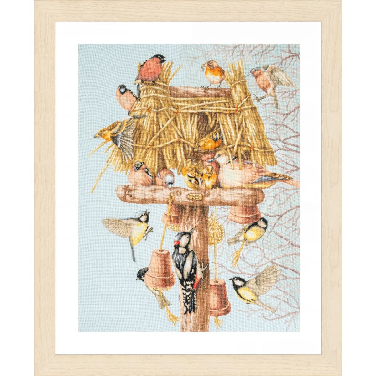 A framed illustration of various birds gathered around a...