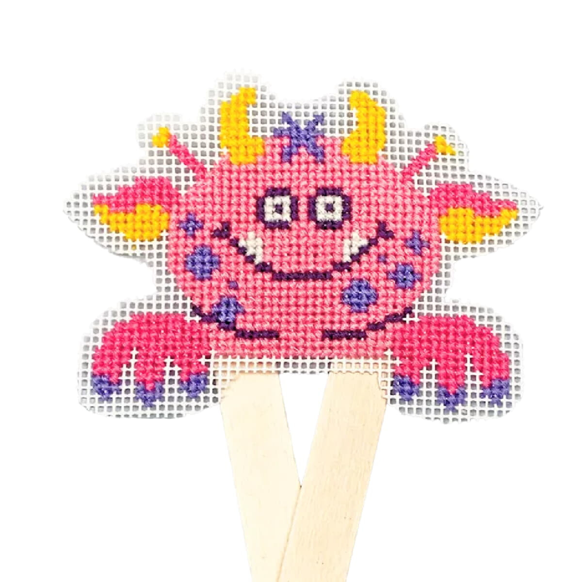 An adorable cross stitch picture of a pink, smiling,...